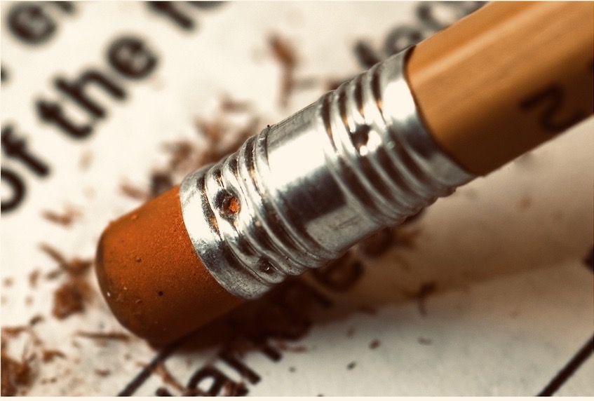 A close-up view of a pencil with an eraser