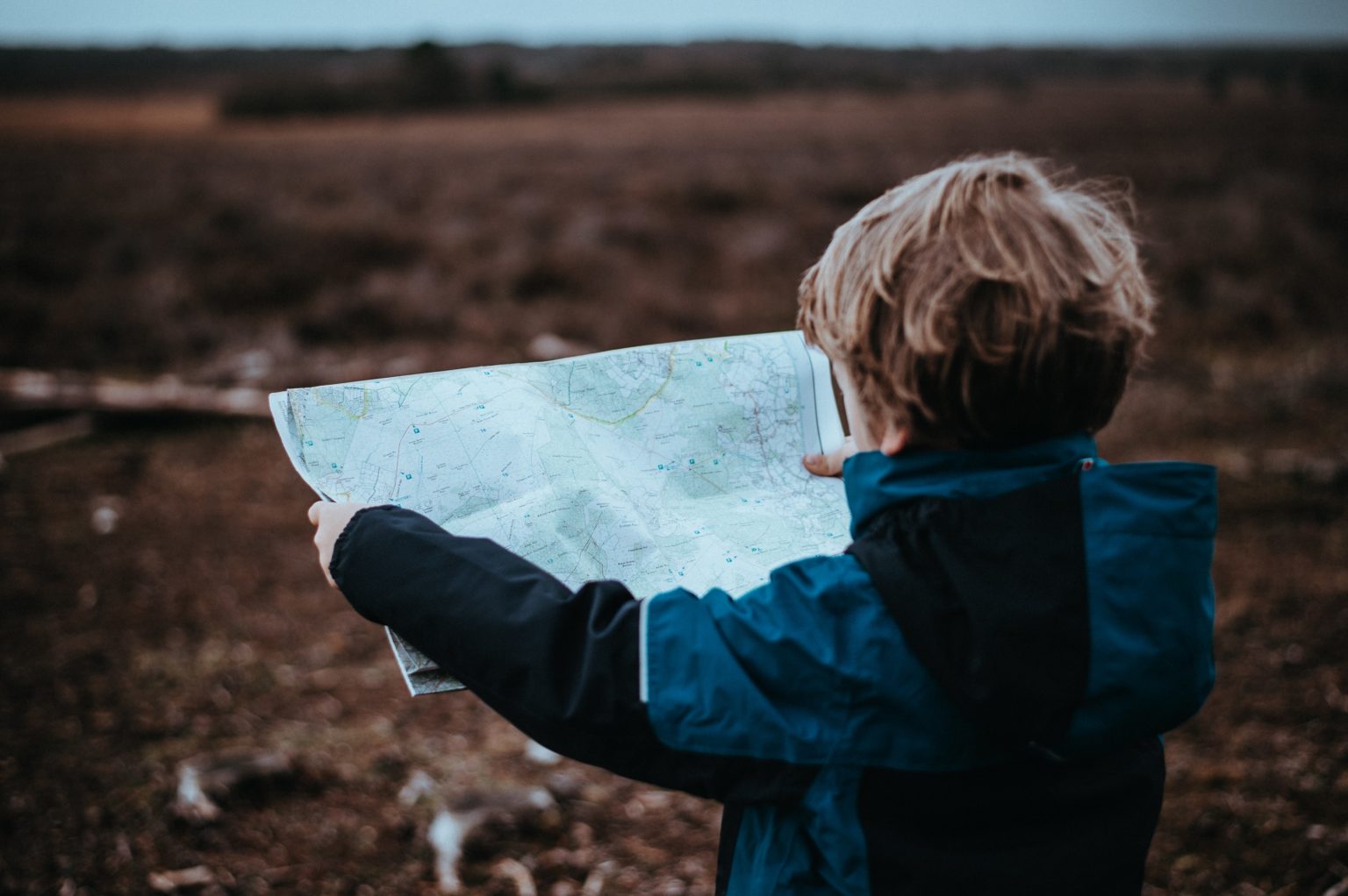 A child standing and holding a map