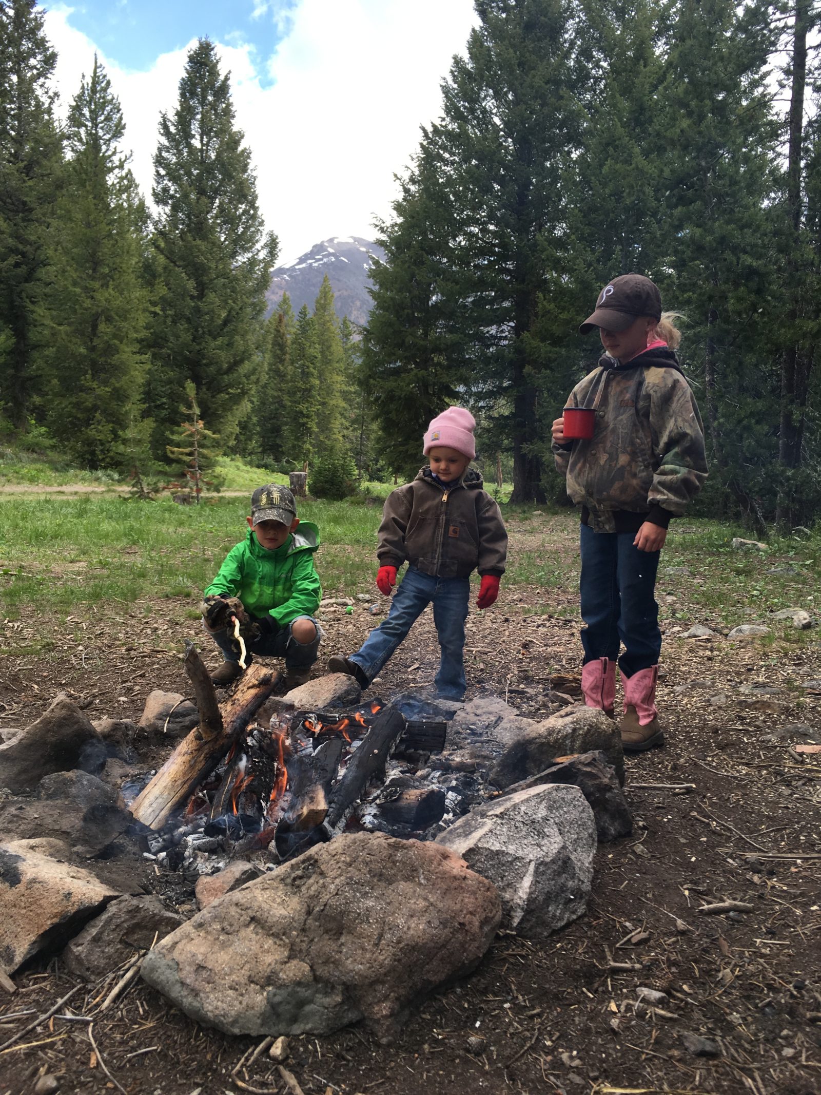A family standing near a fire pit